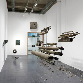 A modern exhibition space with hanging sculptures made of various materials. The floor is covered with fragments and artifacts. | © Courtesy the artist and Vigo Gallery, London
