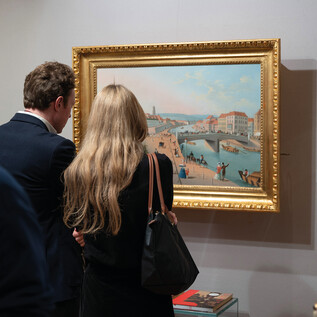 Zwei Personen betrachten ein Gemälde in einem Museum. Im Hintergrund sind die Umrisse von anderen Ausstellungsstücken zu sehen. | © Michael Otto