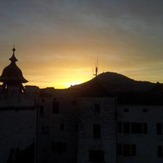 Historická kuchyně se starými kuchyňskými potřebami a kamenným krbem. Podlaha je z velkých kamenů a jsou zde různé hrnce a konvice. | © Festung Hohensalzburg