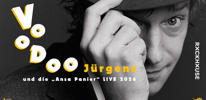 A black-and-white image of a man with a hat looking at the camera. The text "Voodoo Jürgens and the 'Ansa Panier' LIVE 2026" is prominently placed. | © Susanne Hassler-Smith