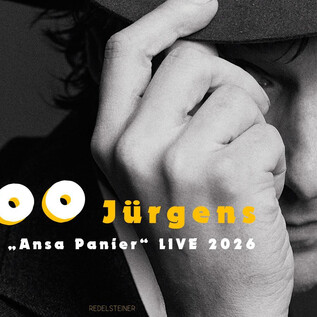 A black-and-white image of a man with a hat looking at the camera. The text "Voodoo Jürgens and the 'Ansa Panier' LIVE 2026" is prominently placed. | © Susanne Hassler-Smith