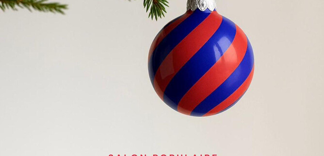 A Christmas bauble hangs from a branch. The background is bright and neutral. | © Schauspielhaus Salzburg